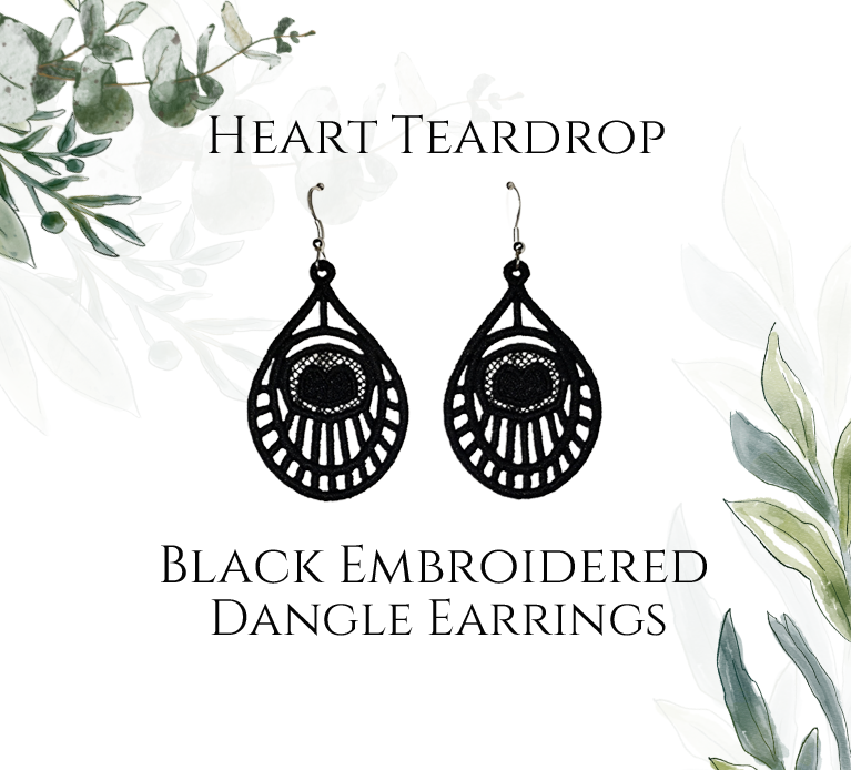 Lightweight Heart Teardrop Embroidered Black Dangle Earrings with sterling silver ear wires on a white and green foliage background image.