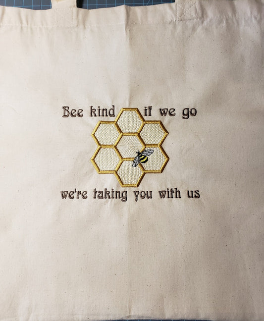 Natural colored cotton tote bag with a  Bee and honeycomb with the phrase Bee kind, if we go we're taking you with us
